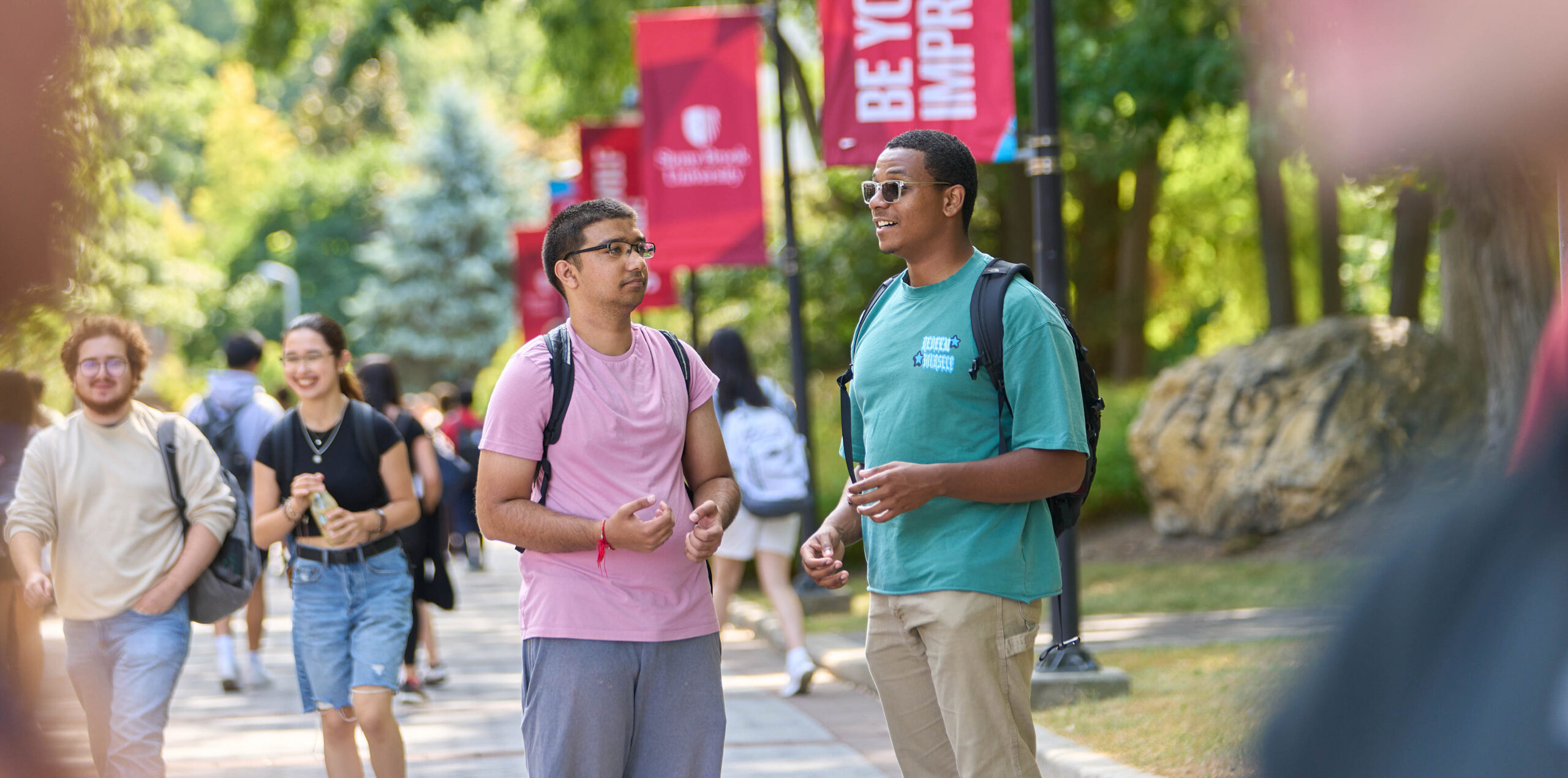 Students walking and engaging on Stony Brook’s Academic Mall.
